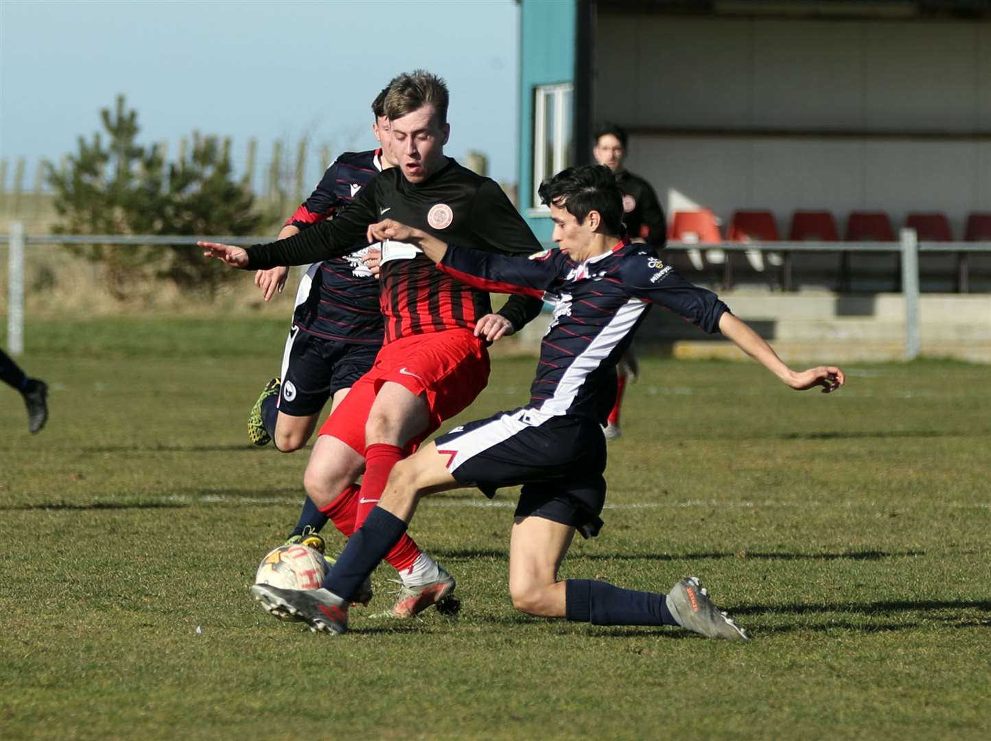Halkirk United's Sam Barclay is tackled by Danni Bruce of Inverness Athletic. Picture: James Gunn