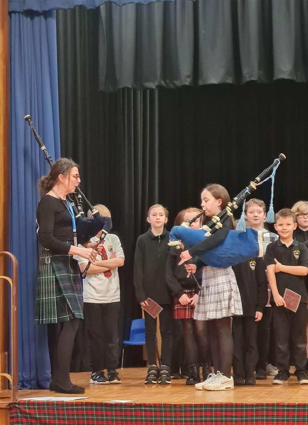 Emme Spence, P7, and Shona McNicol, P6 teacher, piped in the haggis.