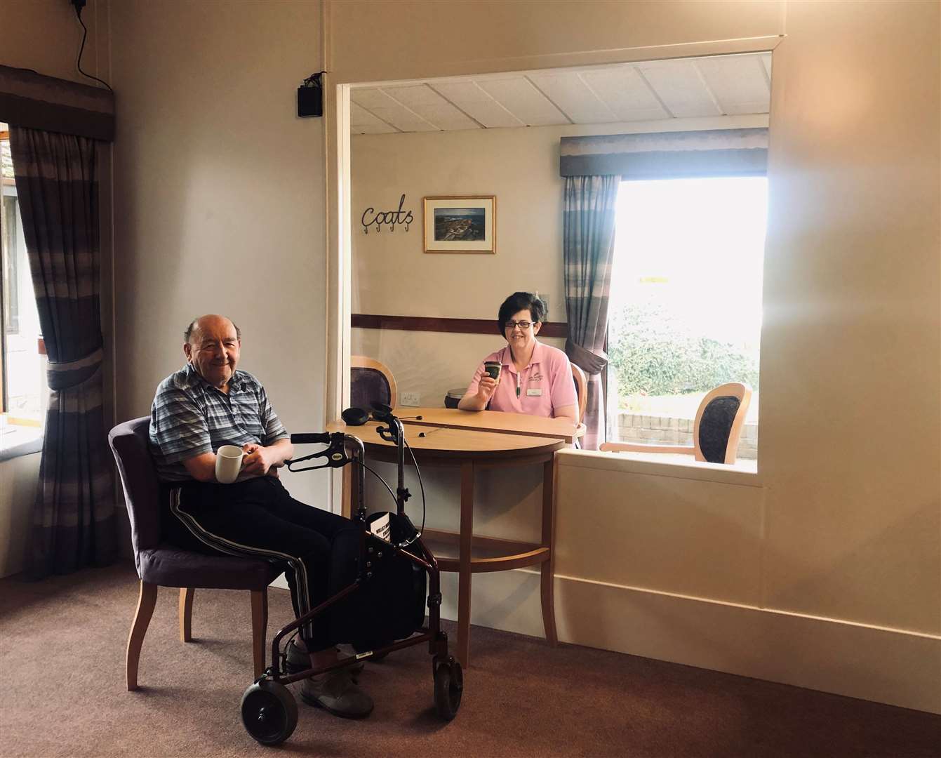 Seaview House resident Willie Cuthbertson and activities co-ordinator Mandy Wilson demonstrating the new visiting suite.