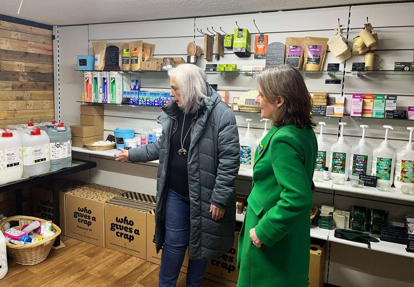 Helen Allan (left) showing Maree Todd the Socially Growing refill shop, one of Thurso Community Development Trust's projects.