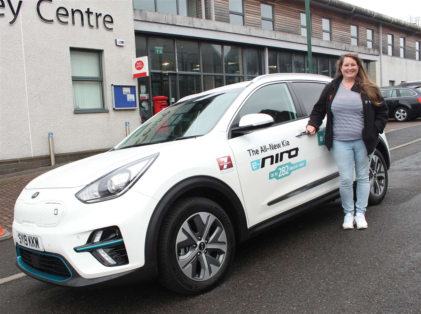 Becky Fretwell, sustainable transport co-ordinator at Home Energy Scotland, with the Kia e-Niro electric car outside the Pulteney Centre.
