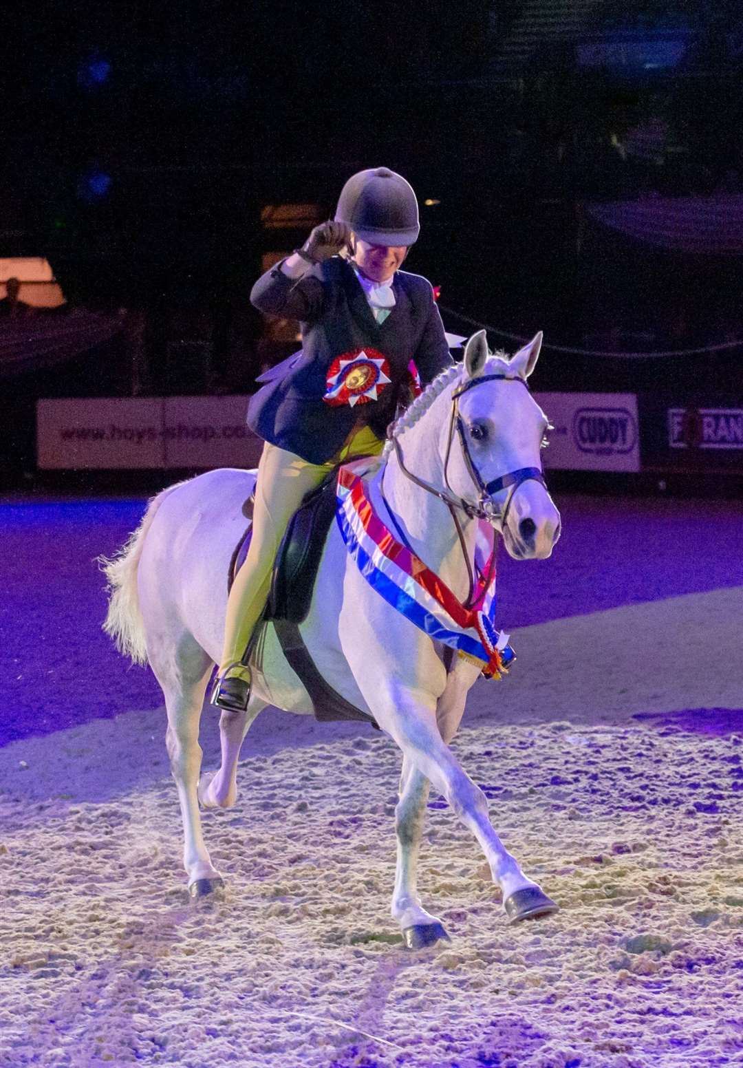 Coco Bongo and Chloe Lemieux pictured under the spotlight as they enjoy their lap of honour after being crowned Ruckleigh School Supreme Pony of the Year 2019 at HOYS. Picture: Julian Portch
