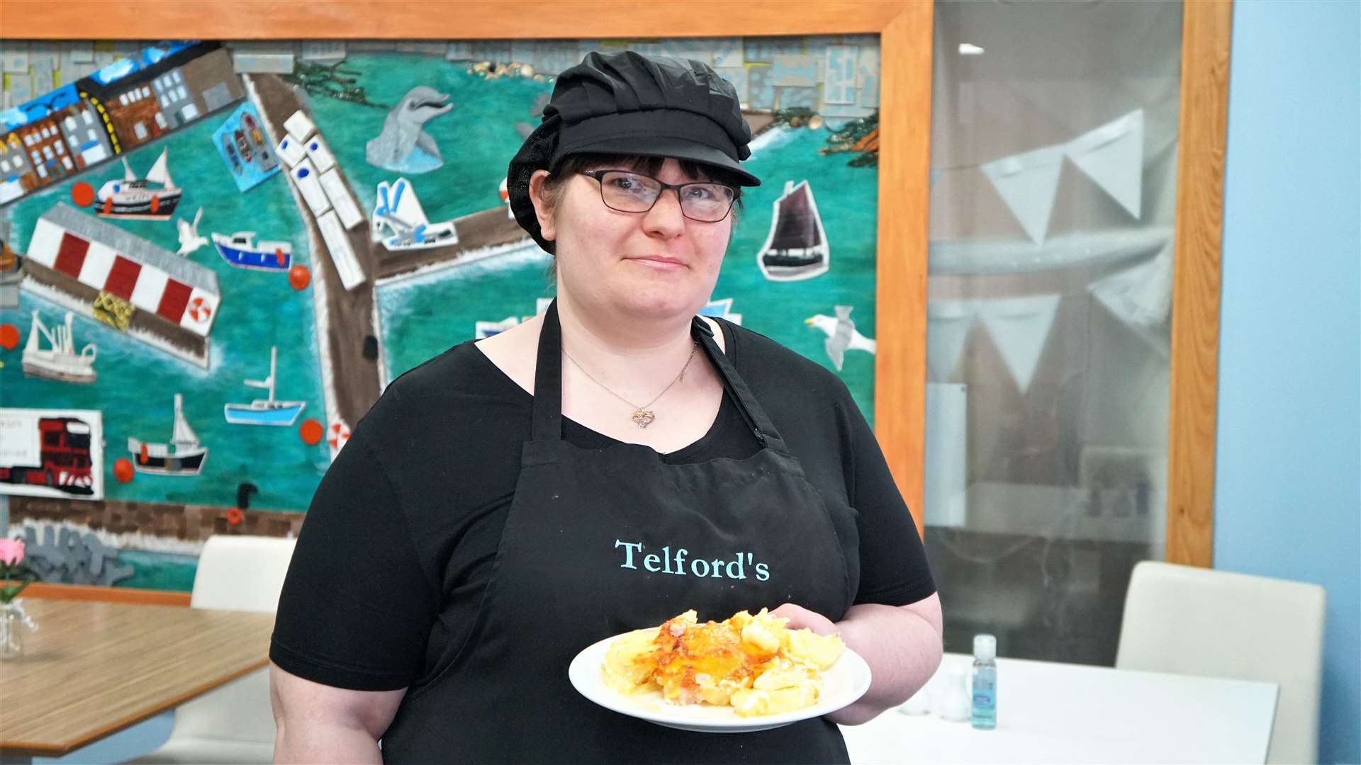 Rose McGowan has been working as a cook at the community café since November last year. She is showing a typical meal served up at the centre – a potato, cheese and bacon bake. Picture: DGS