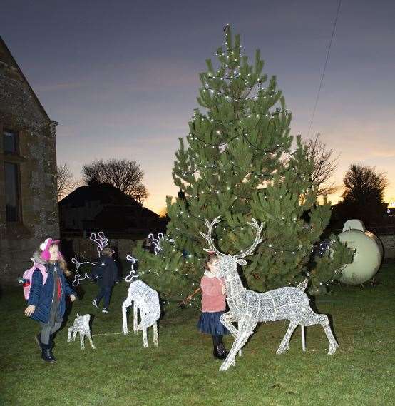 Some of the village children explore the Christmas scene outside Reay village hall following the lights switch-on.