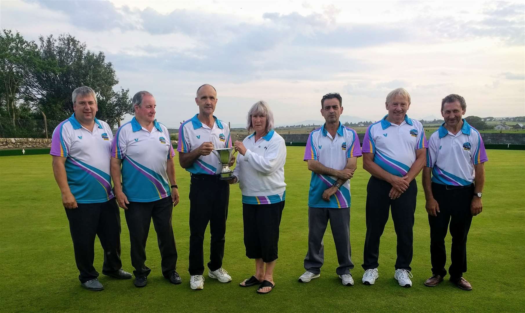 From left: The winning team of Sandy Mackay, Jim Fraser and John Grant with Lybster president Fran Manners presenting the trophy, along with runners-up George Zindilis, Douglas Sutherland and George Sutherland.