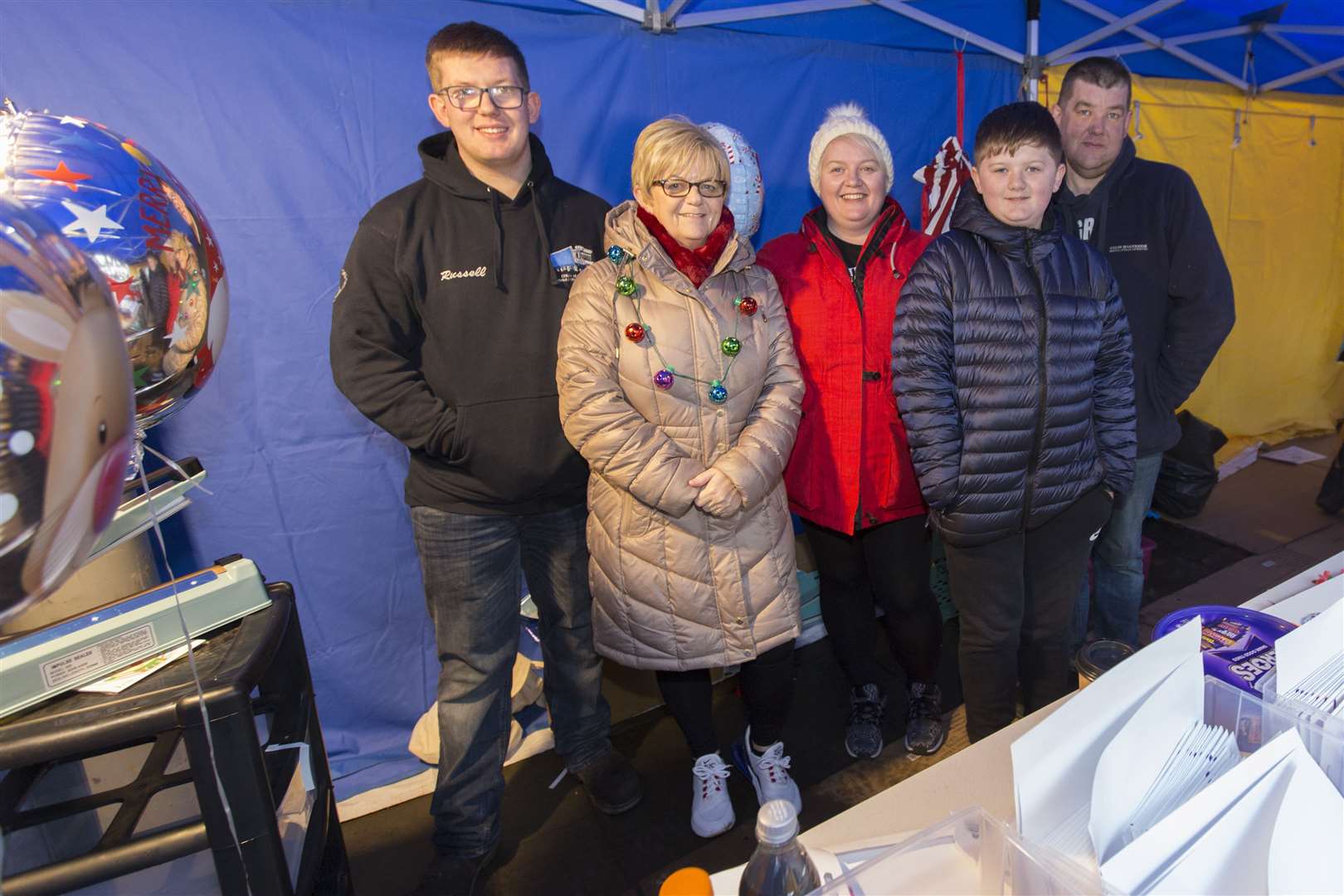 Claire Mackenzie (centre), chairperson of Wick Christmas Lights Committee, had family help on the group's stall. From left are her son Russell, mother Eleanor, son Brody and husband Graham. Picture: Robert MacDonald / Northern Studios