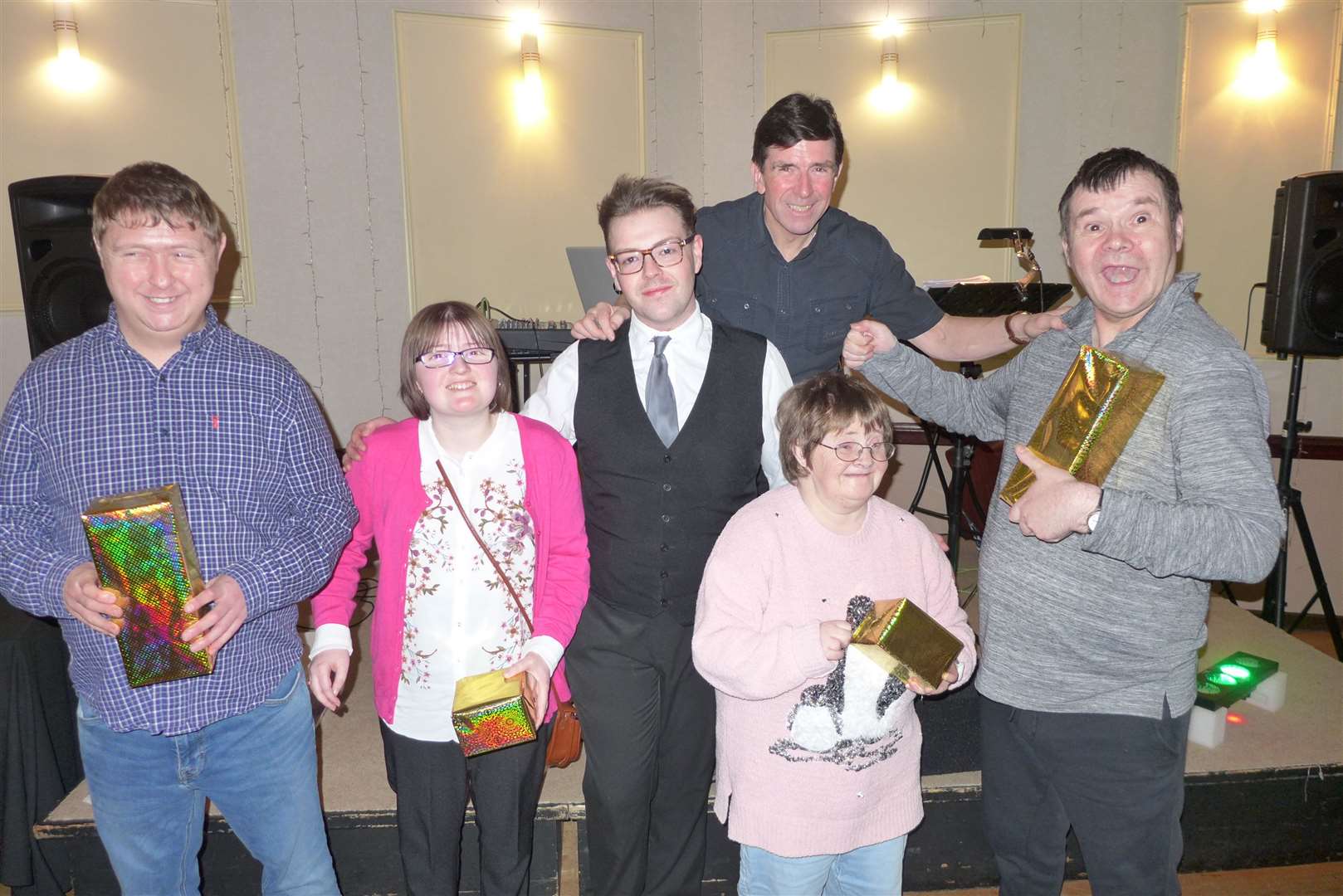 Craig Mathieson (centre) hands over prizes to the lucky spot-dance winners of the afternoon (from left), Christopher Nichol, Charlene Wilkinson, Eileen Crocket and Ronald Harris, with musician Colin McFeat looking on. Pictures: Willie Mackay