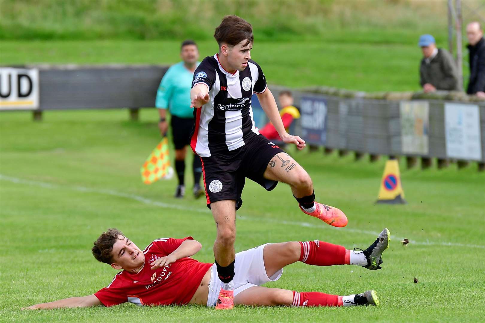 Gary Pullen of Wick Academy hurdles a challenge from Deveronvale defender Jayden Goldie during the league match at Harmsworth Park in August which the visitors won 1-0. Picture: Mel Roger