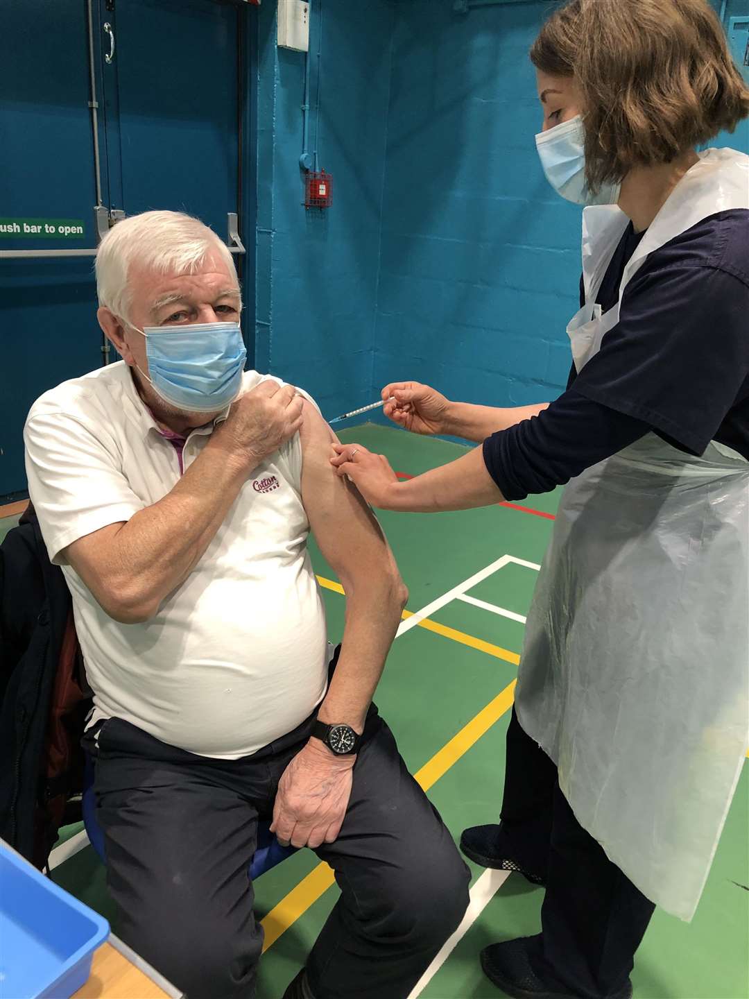 Pete Rogers receiving the first vaccine from Shona Gunn, one of the advanced nurse practitioners.