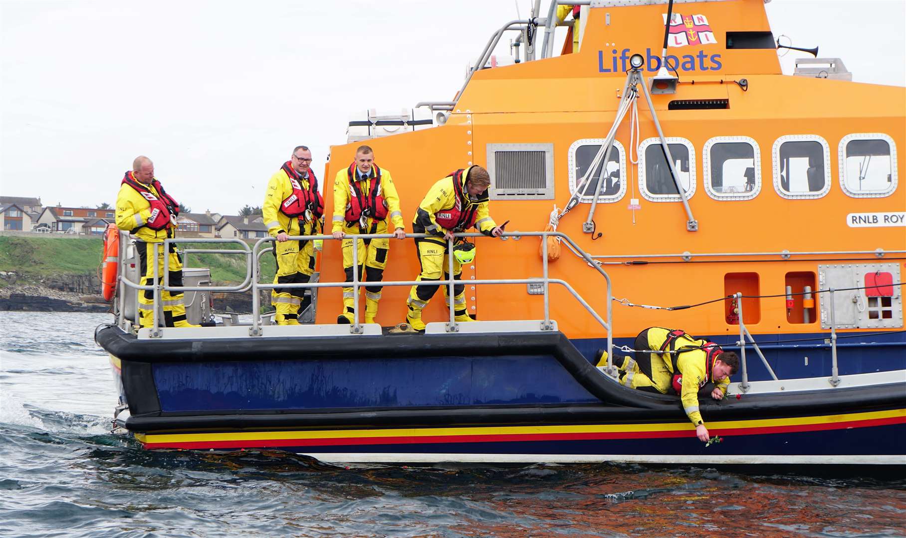 A flower is laid by a Wick lifeboat crew member. Picture: DGS