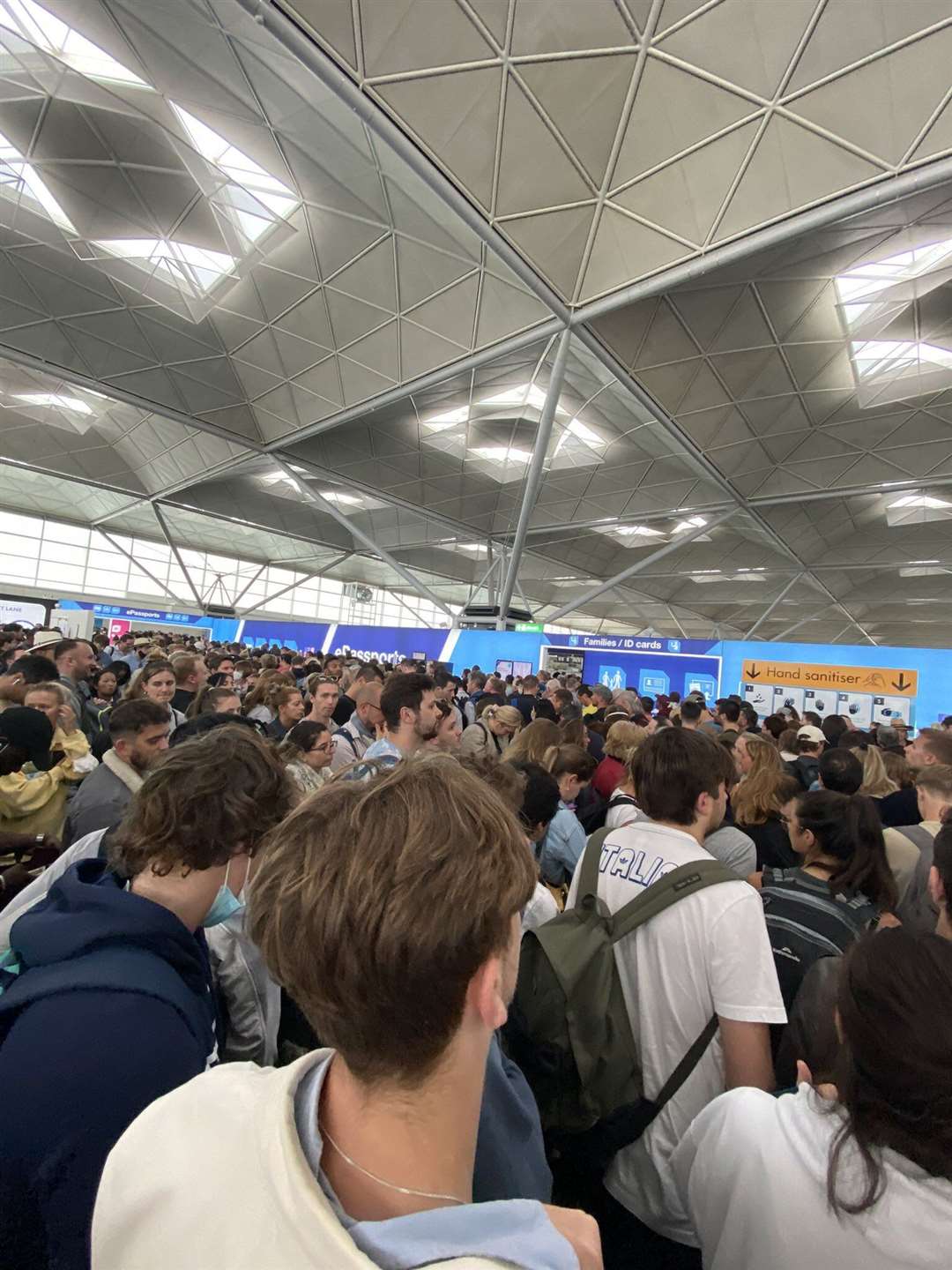 People queuing at Stansted Airport (@CJvsn/PA)