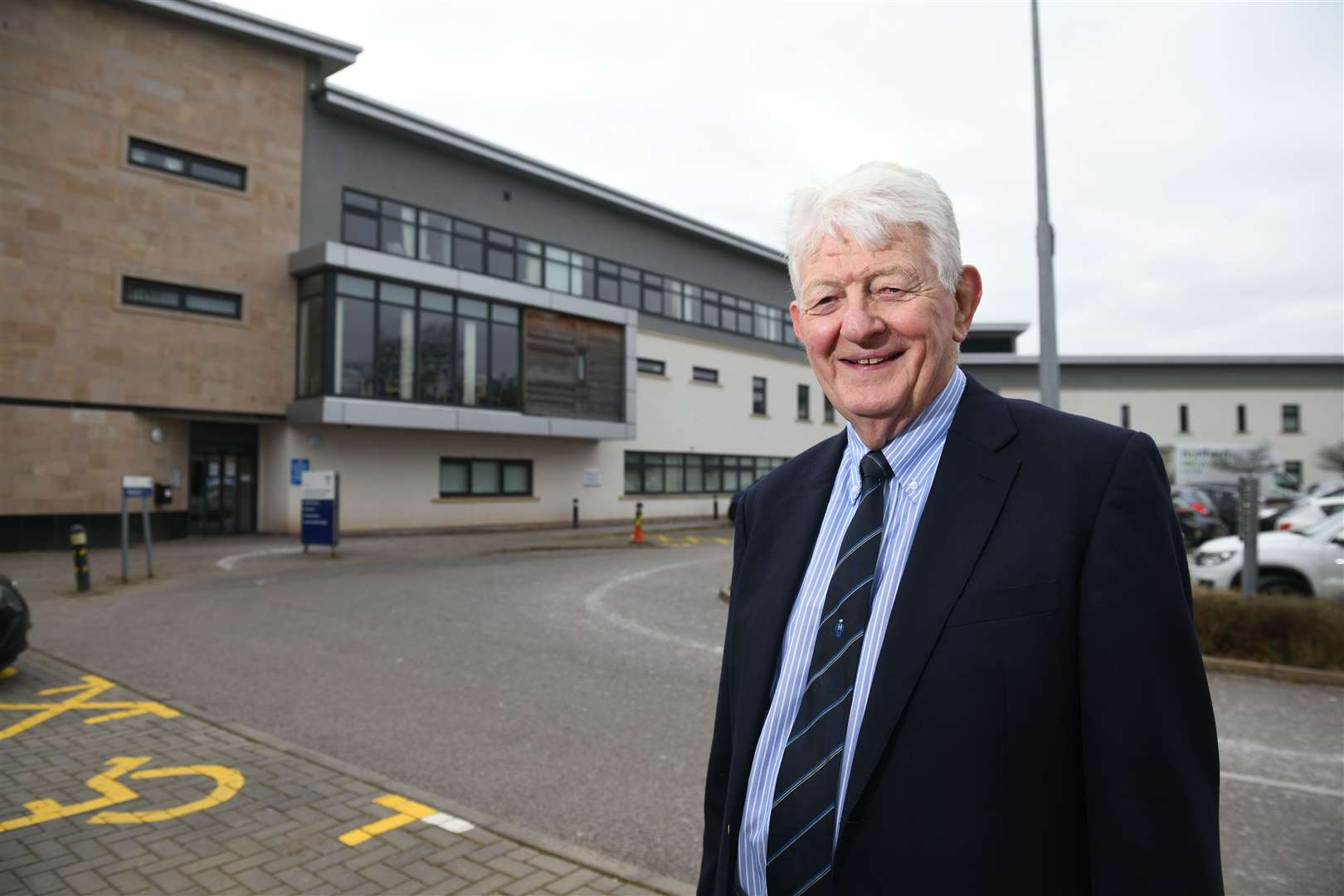 Alastair Noble, former GP and Chair of Nairn West and Suburban Community Council standing outside Nairn Town & County Hospital and Primary Care Centre. Picture: James Mackenzie.