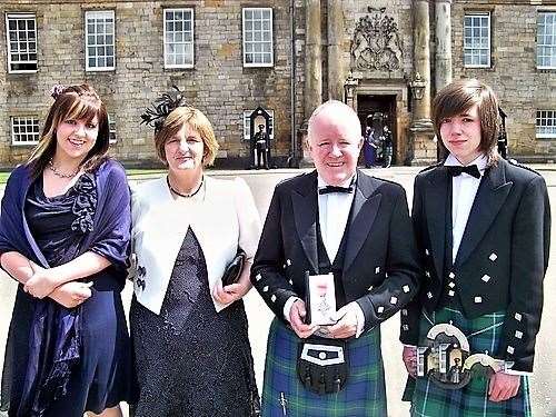 Pat with his family at Holyrood Palace when he received his MBE in 2010.