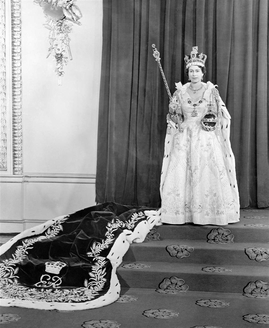 The Queen wearing the the Coronation dress and robe in the Throne Room at Buckingham Palace, after her Coronation in 1953 (PA)
