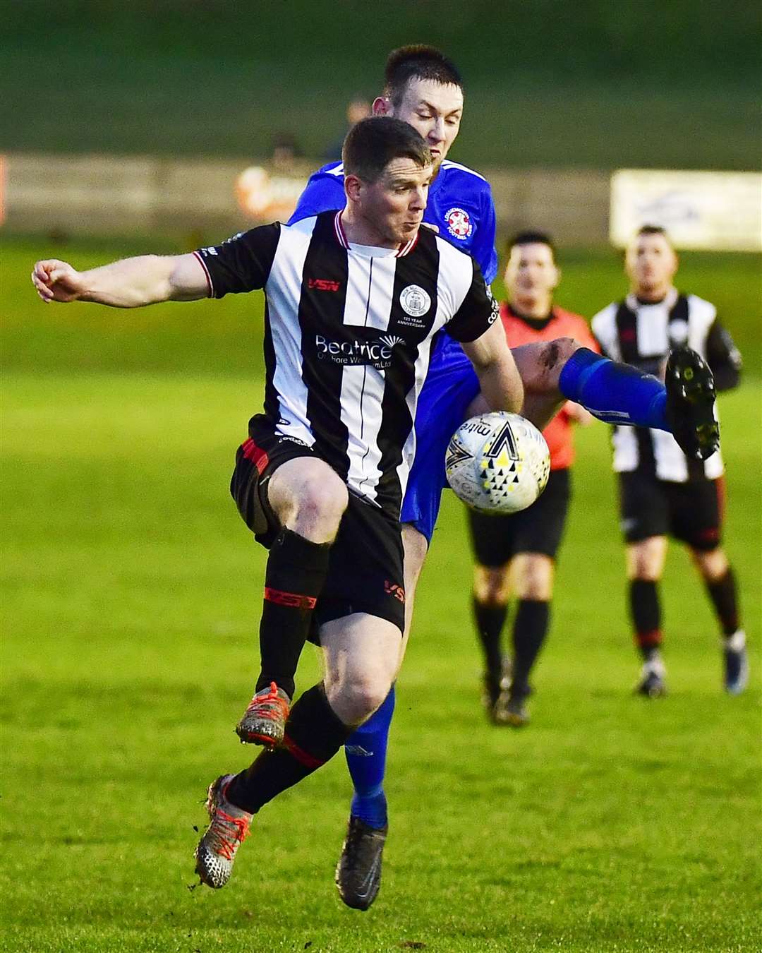 Wick's Davie Allan receives the ball as Lossiemouth's Dean Stewart closes in. Monday's game was the first at Harmsworth Park since new protocols came into effect. Picture: Mel Roger