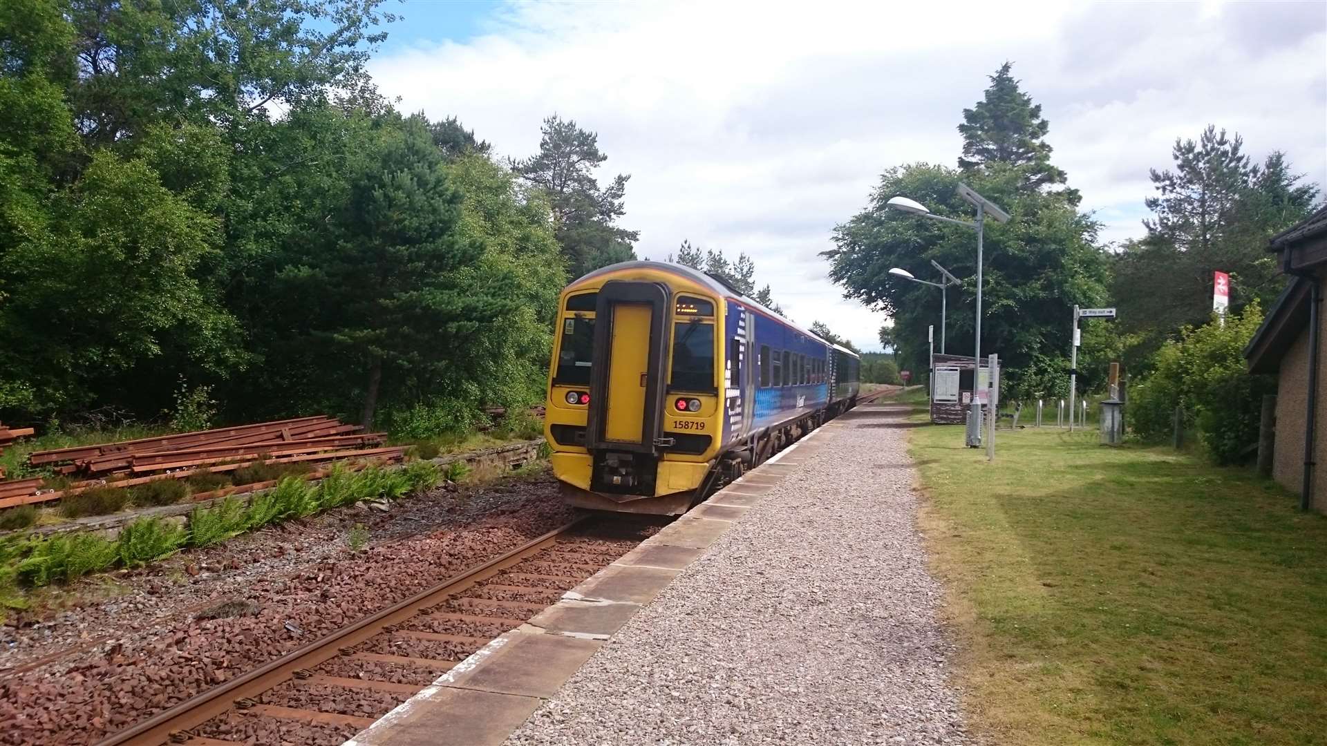 A ScotRail train pulls away from the platform at Altnabreac on the Far North Line.