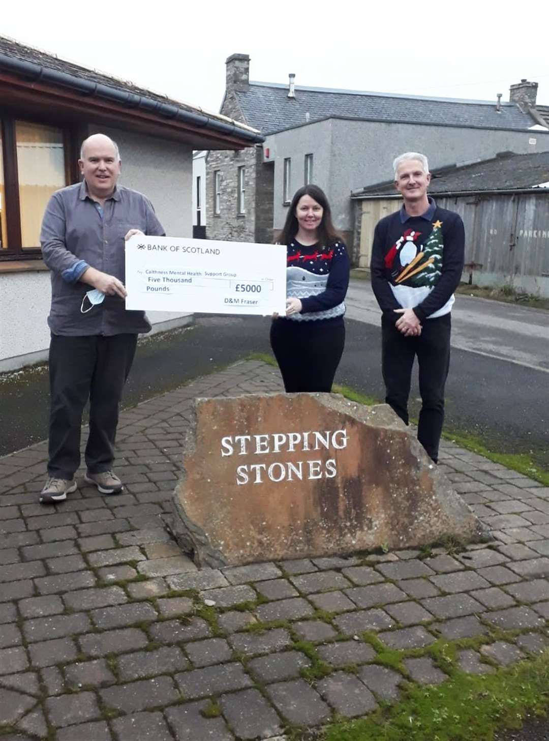 D&M Fraser director Lesley Mill and manager Scott Macdonald (right) handing the £5000 cheque to Chris Mackenzie of Caithness Mental Health Support Group.
