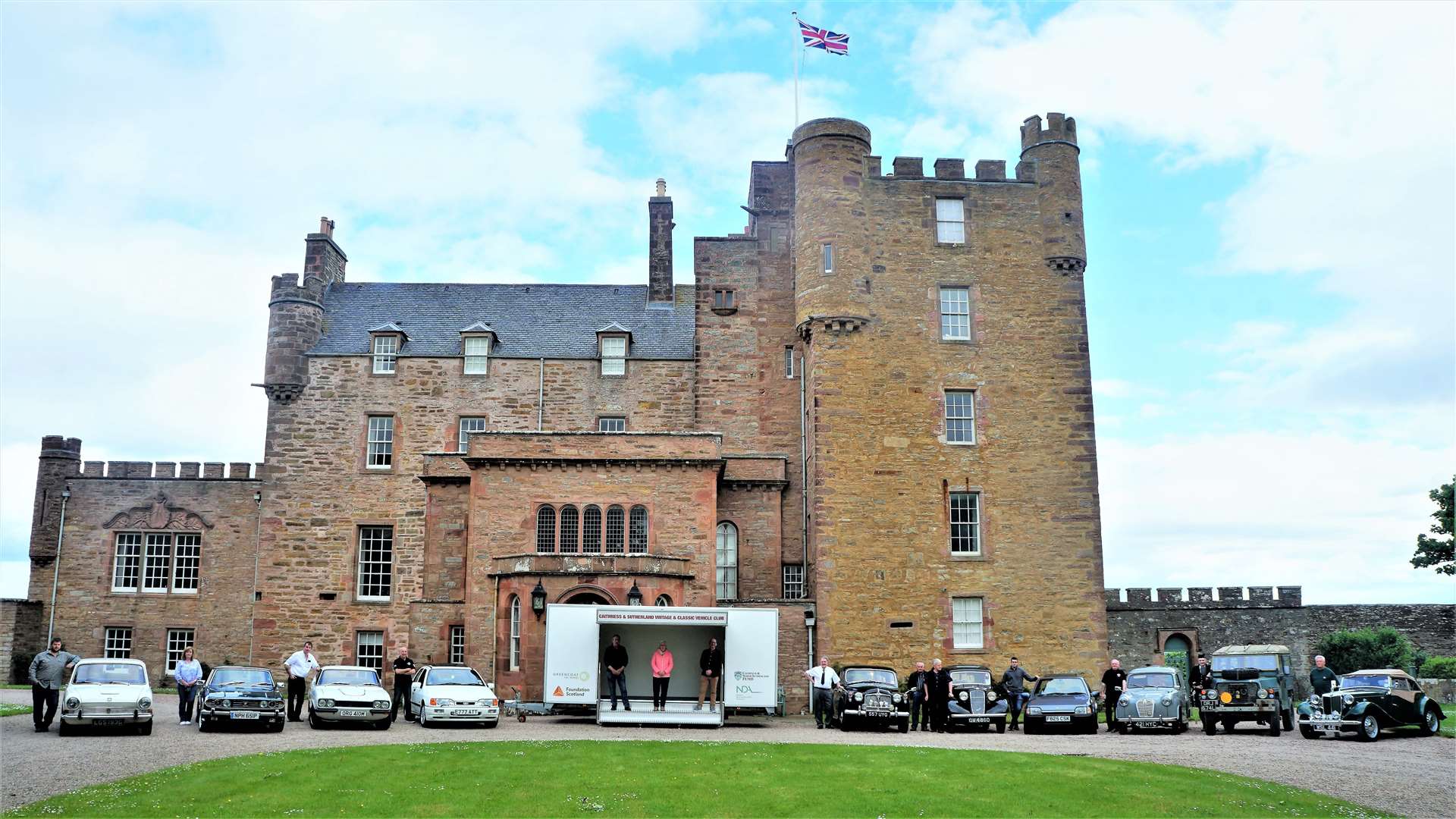 Members of the Caithness and Sutherland Vintage and Classic Vehicle Club line up with their cars at the front of the Castle of Mey on Sunday morning. Picture: DGS