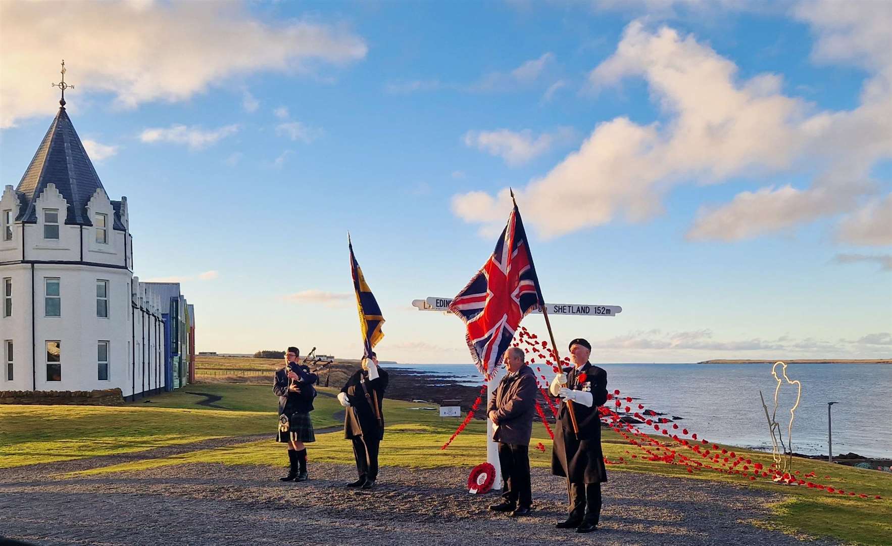 The Remembrance Sunday ceremony at the John O'Groats signpost.