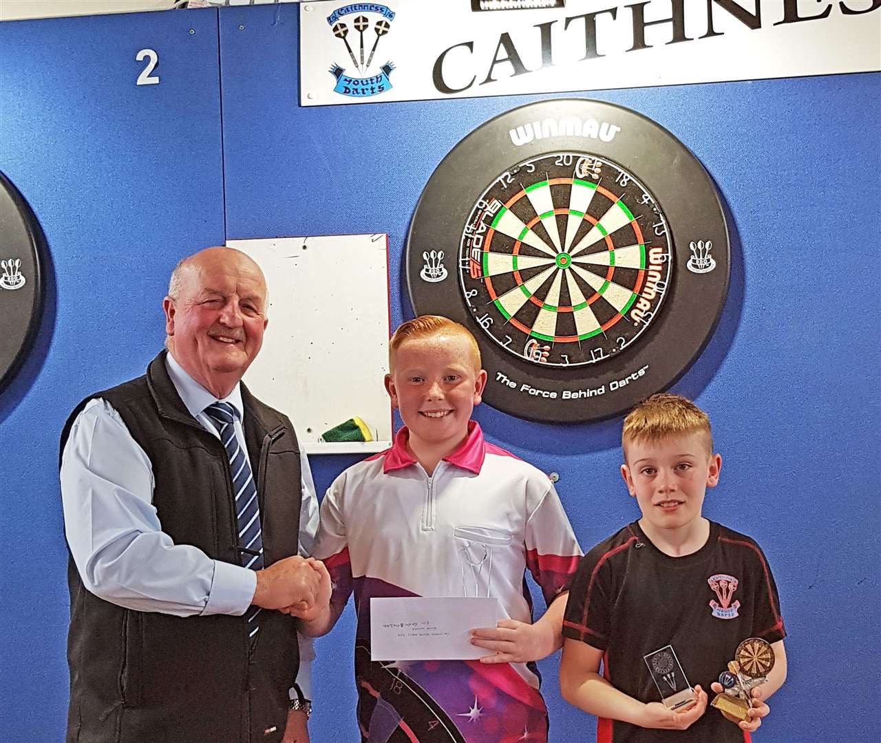Caithness civic leader Willie Mackay presents Baxter MacIntosh with his winnings, watched by runner-up Logan Moodie.