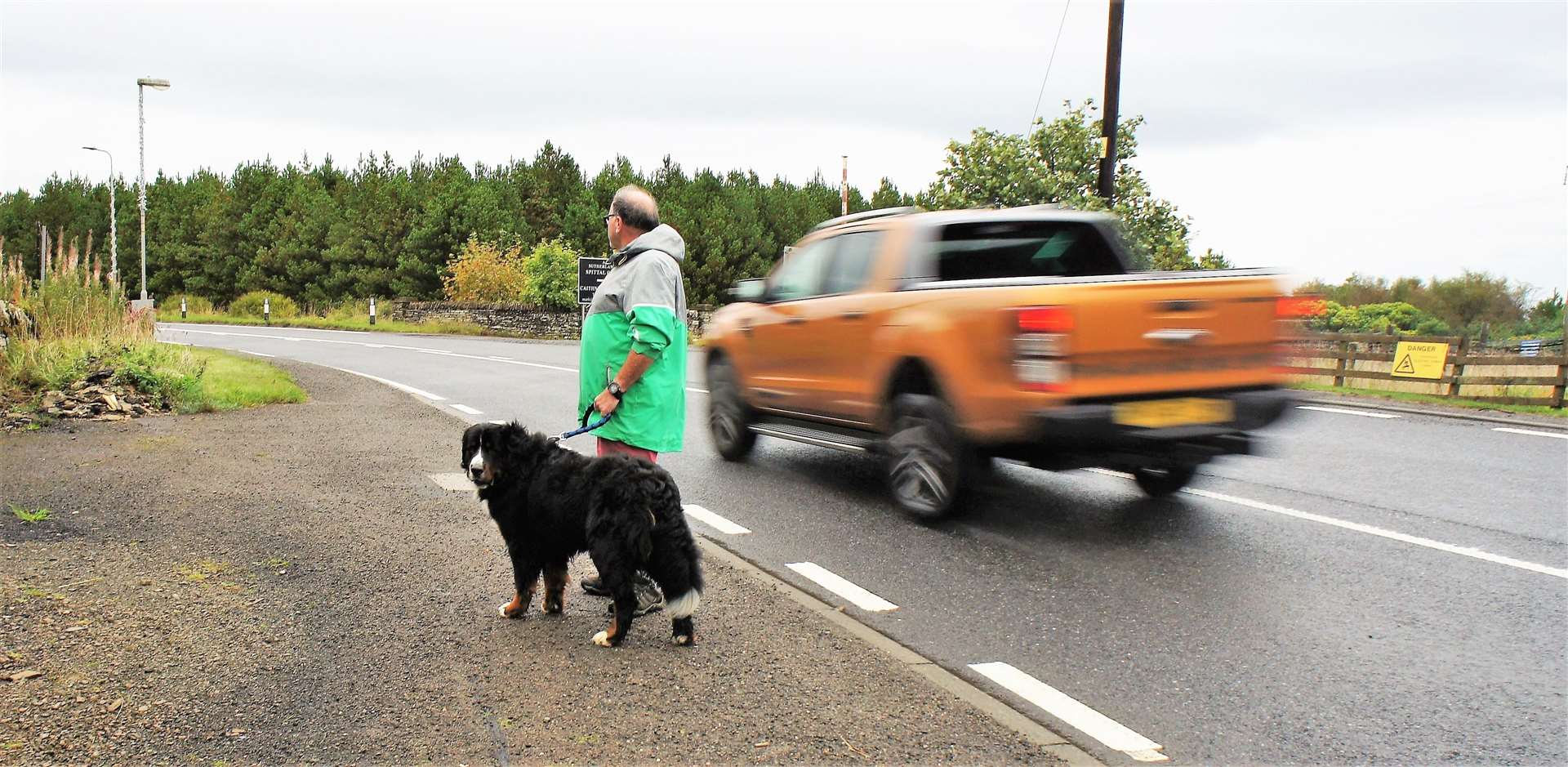 Eddie Rowan walks his dog beside the section of the A9 through Spittal that he says is dangerous for pedestrians and pets due to motorists breaking the speed limit. Picture: DGS