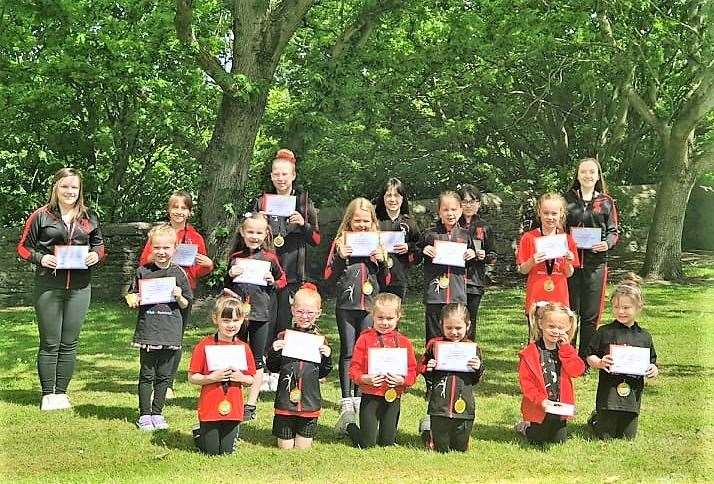 The Marrellian Majorettes receiving their certificates and medals from the cheer dance competition.