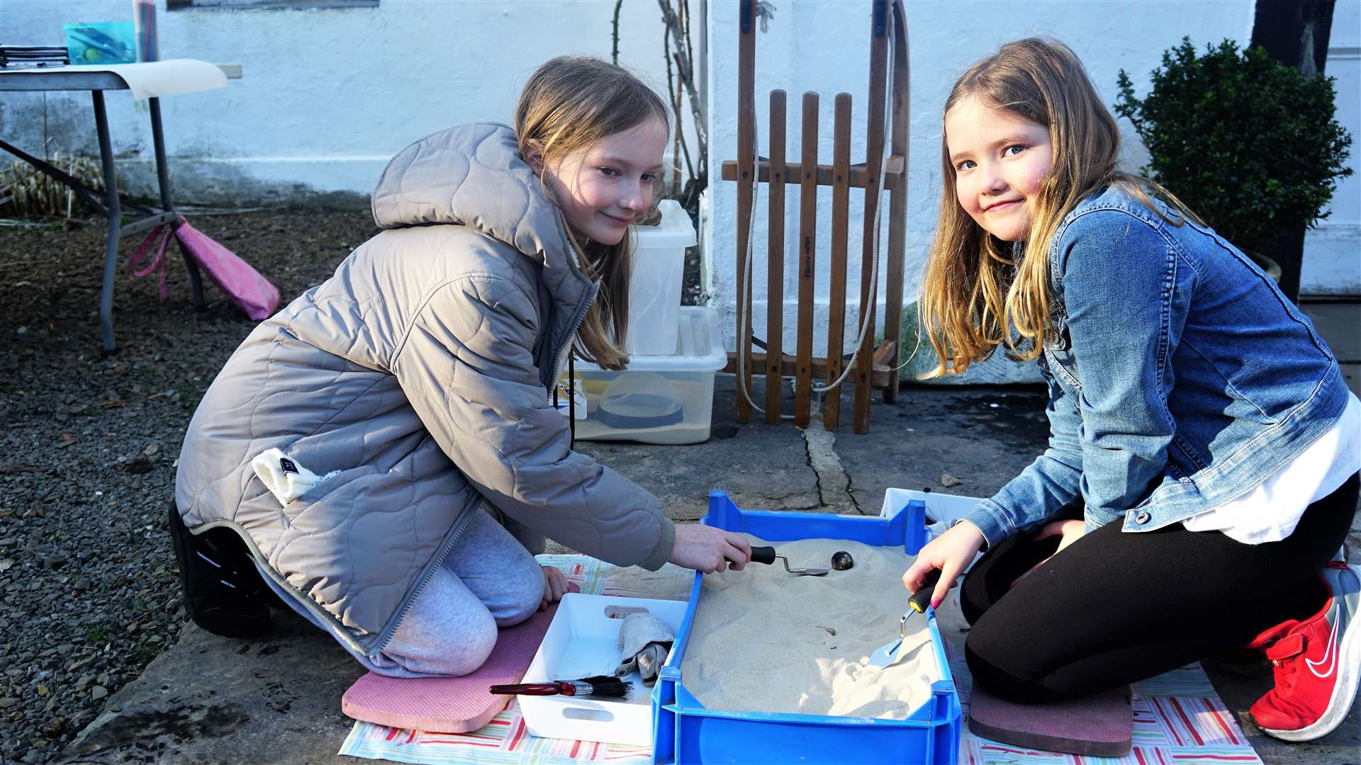 Sisters Zara (left) and Ella enjoyed doing some sandpit archaeology. Picture: DGS