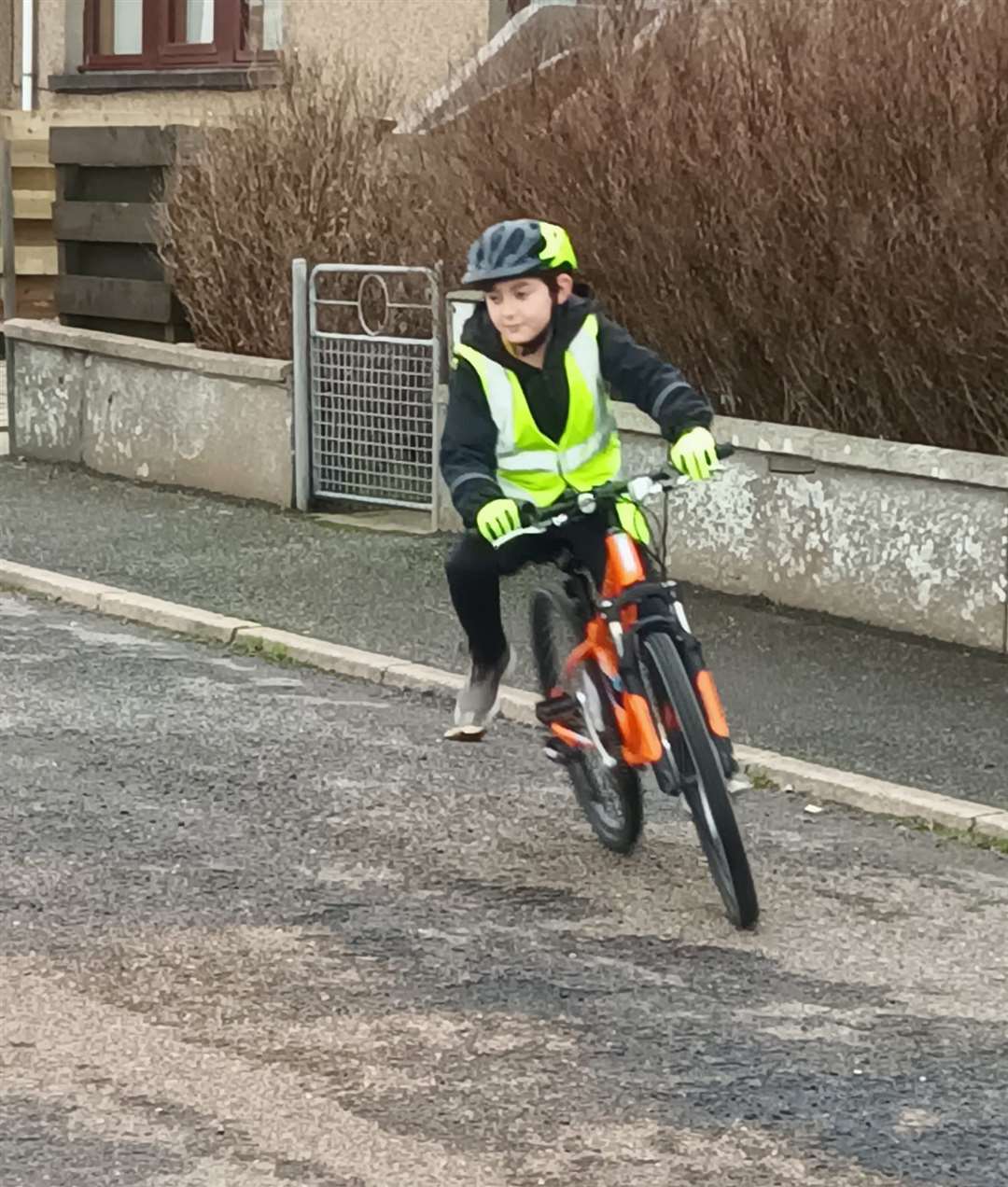 A student gets used to riding a bicycle safely on the road.