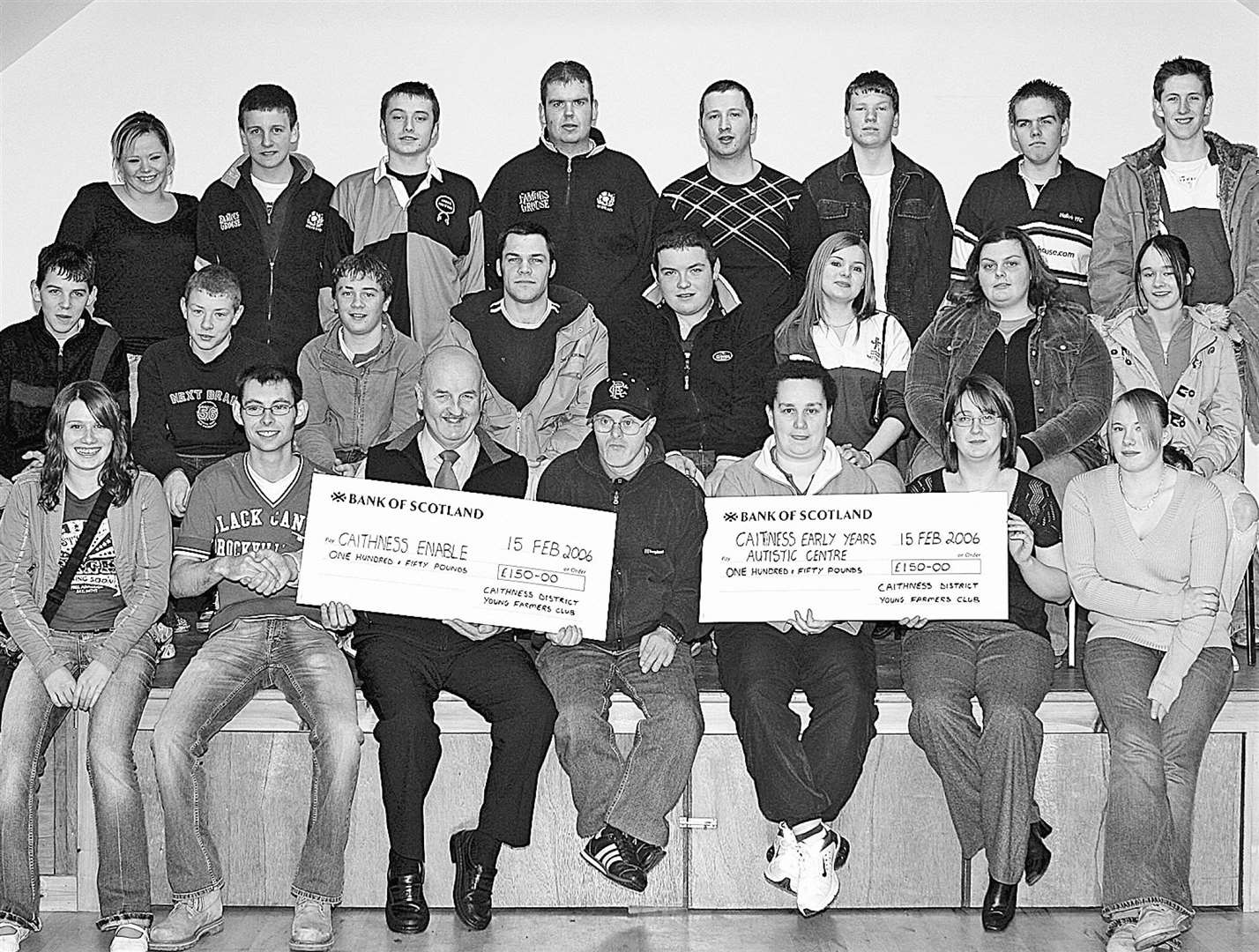 Caithness District Young Farmers presenting cheques for £150 each to the local branch of Enable and Caithness Early Years Autism Centre in 2006. The money was raised at a tractor-pull.