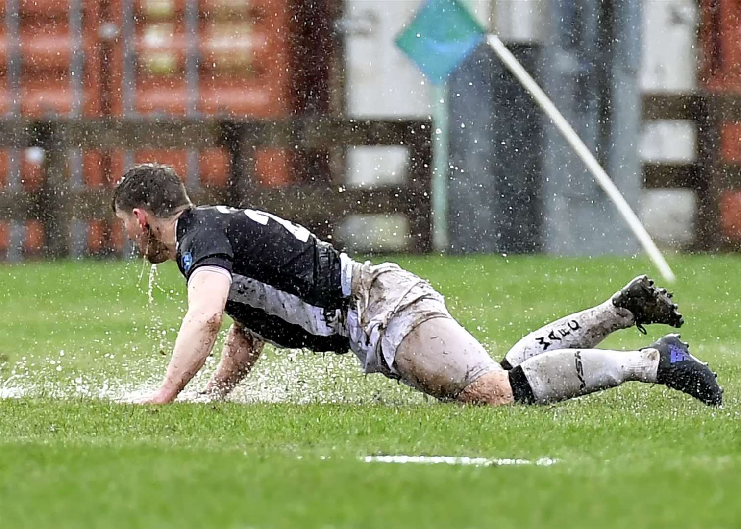 Michael Steven picks himself up from Fort William's rain-soaked Claggan Park in a match that ended up being abandoned. Picture: Mel Roger
