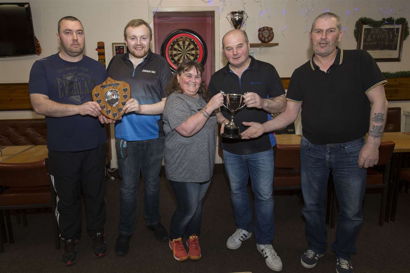 Wick and District Darts Leagues men's first division pairs champions David Taylor (right) and Alan Nicolson, of Harper's B, receive their trophy from Julie Harper. Looking on are second division champions Jordan Oag and Martin Campbell (left), of Smiddy 2. The competition was played in the Seaforth Highlanders' Club. Picture: Robert MacDonald / Northern Studios