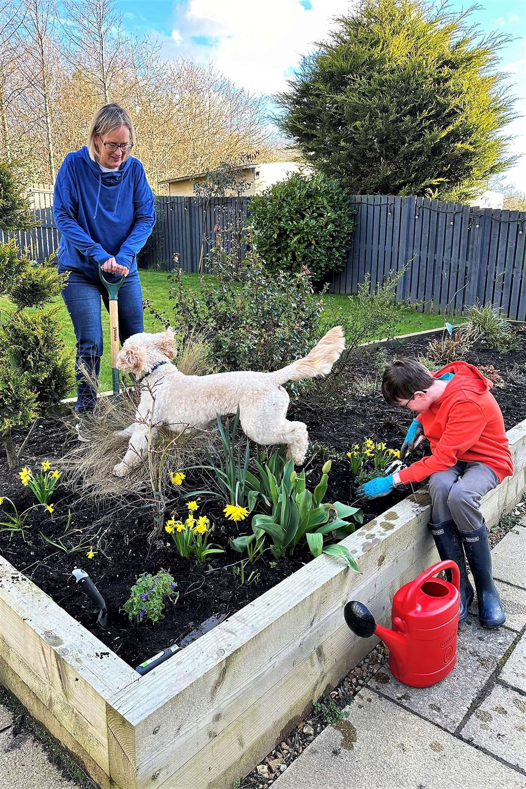 Dawn Lochhead, Scottish Water's Flood Risk Manager, in the garden of her Midlothian home with son Harris and pet dog, Rex. Dawn is an expert on how gardens can be optimised to make optimal use of water and help prevent flooding during rainy weather and to reduce water use during potential drought periods.