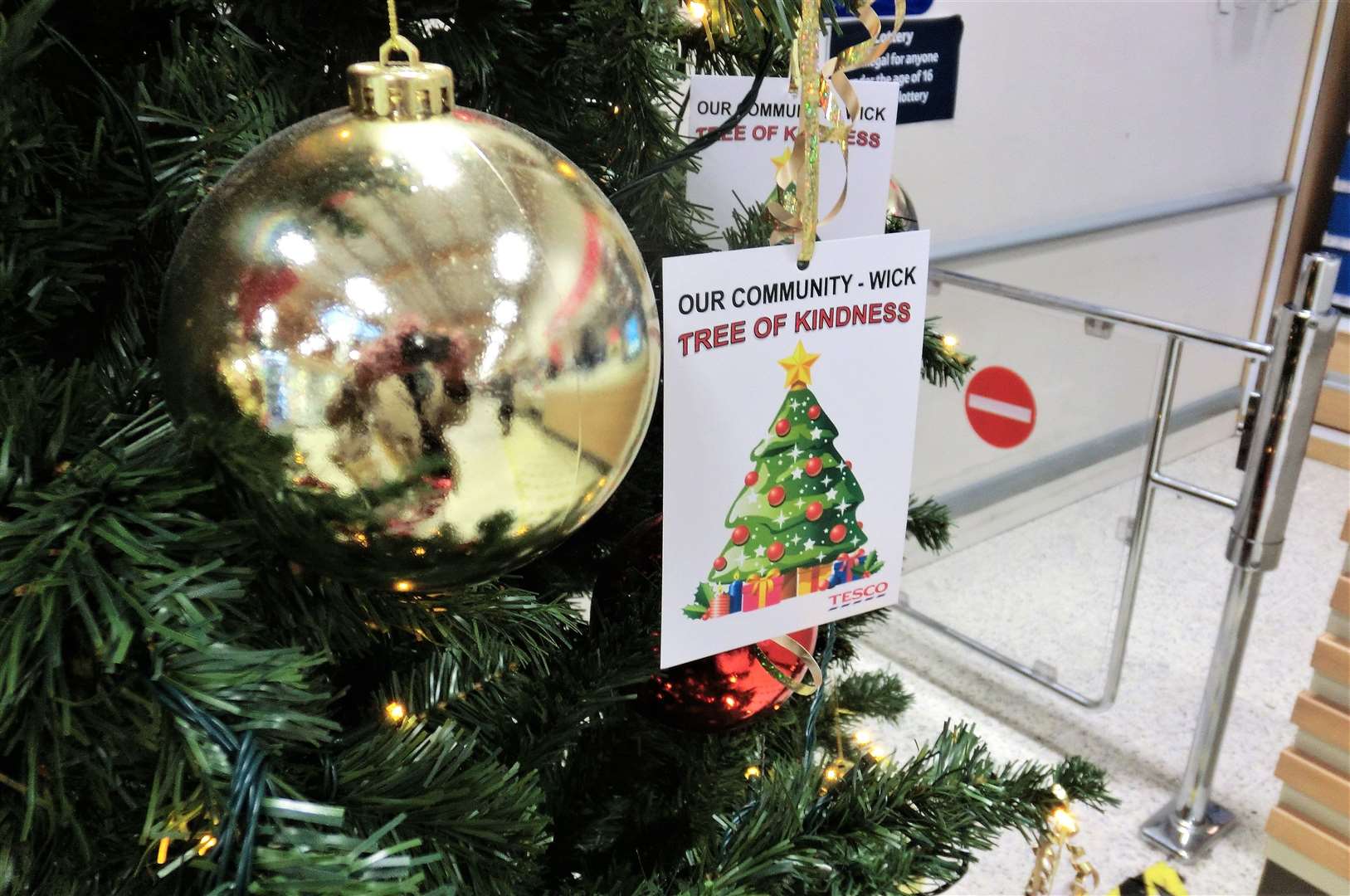 The supermarket invites shoppers to take a gift tag from the tree, purchase the gift and then place it in the designated collection points beside the checkouts.