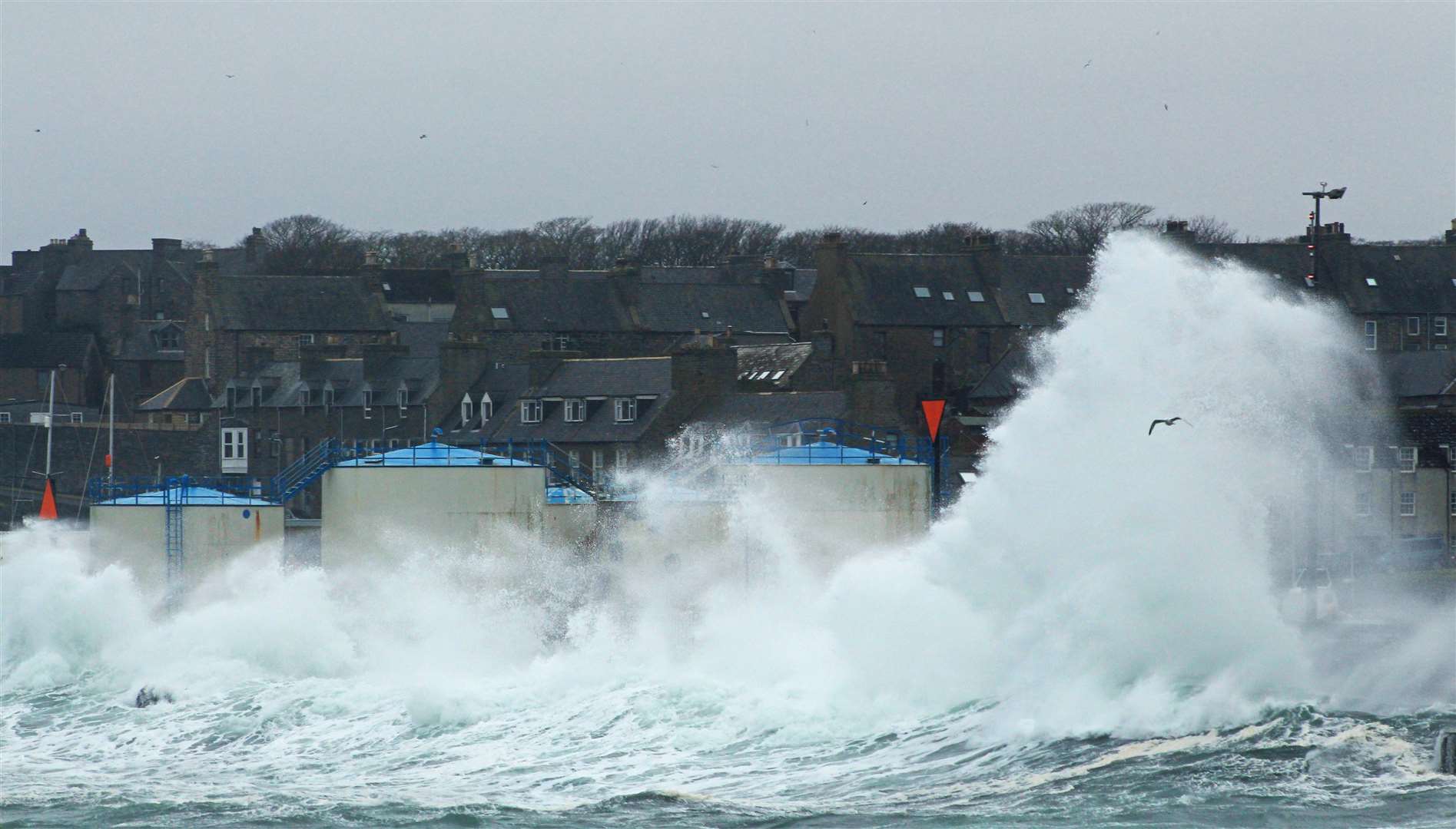 Waves lash against Wick's harbour walls on Sunday afternoon. Pictures: Alan Hendry