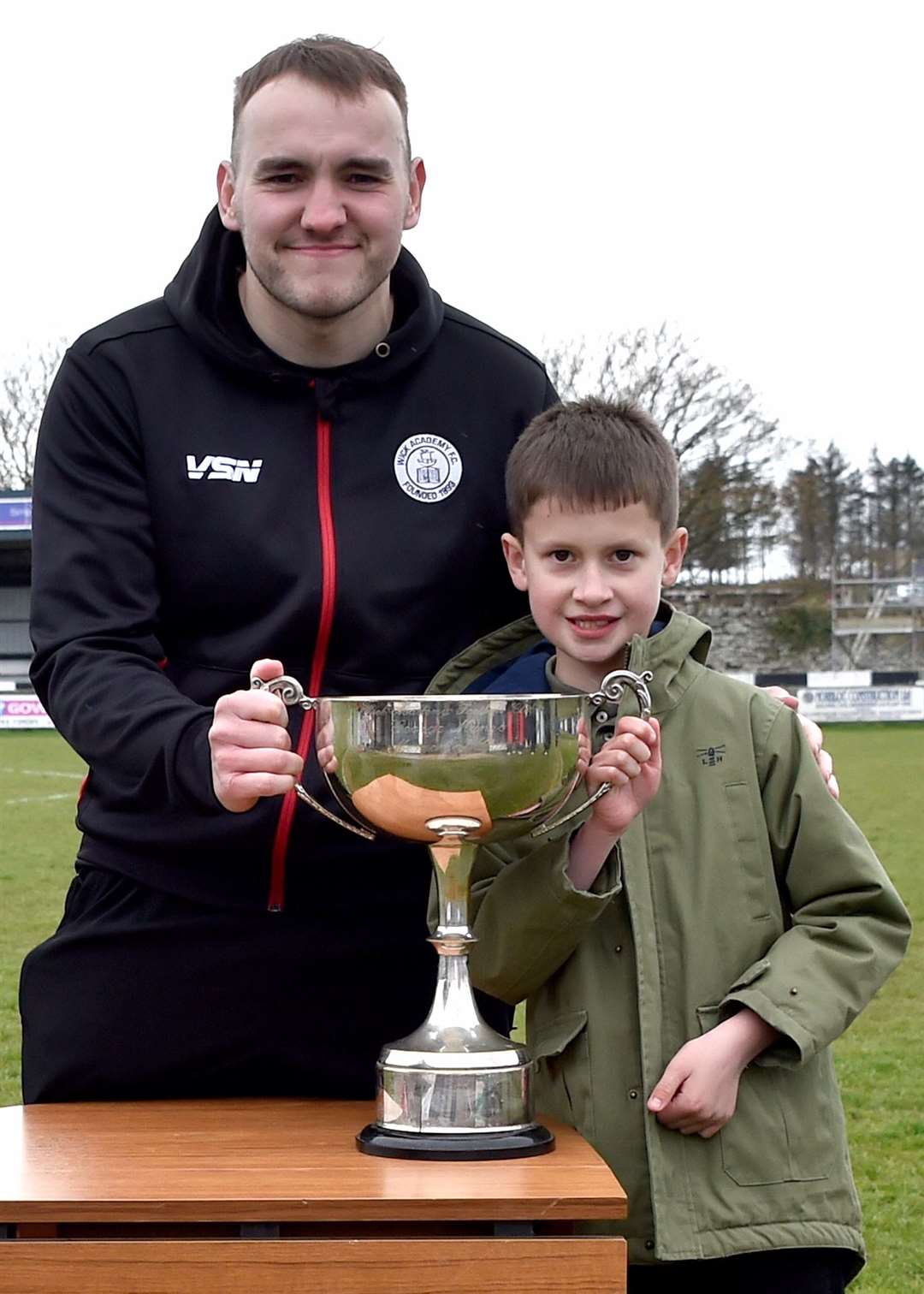Owen Harrold receiving the George Munro Memorial Cup for Wick Academy supporters' player of the year from George Munro's great-grandson Danny Gow. Picture: Mel Roger