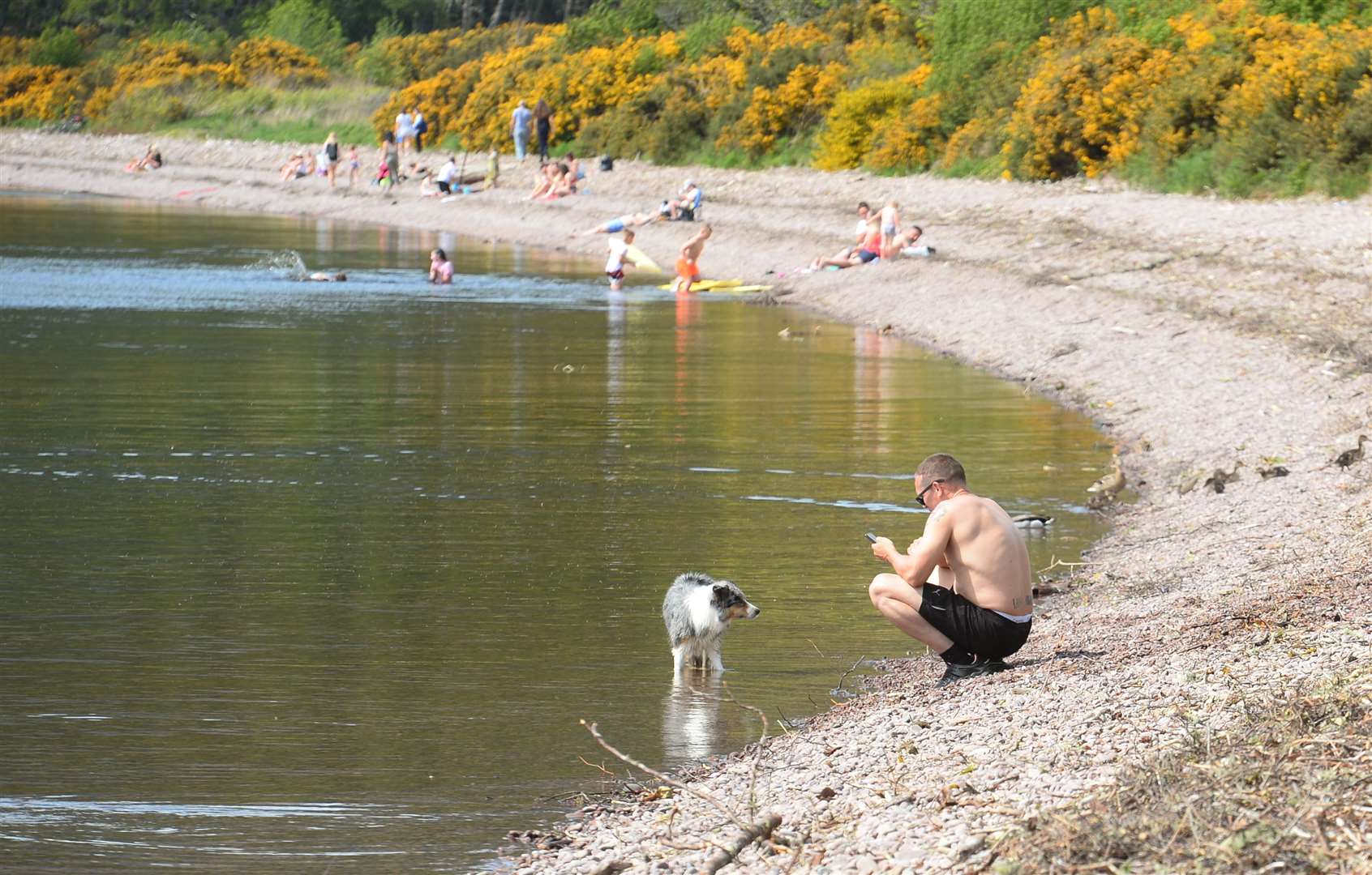 Visitors enjoy the warm weather at Dores beach...Picture: Gary Anthony..