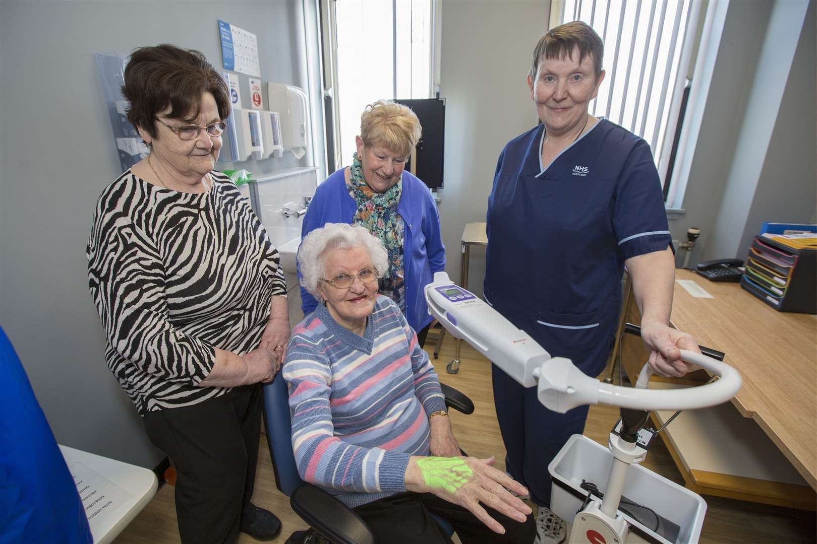 Senior charge nurse Alison Geddes demonstrates the use of the machine on League of Friends of Caithness General Hospital secretary Lottie Shearer, while looking on are chairwoman Annette Sinclair (centre) and treasurer Lorette Mackay (left). Picture: Robert MacDonald/Northern Studios