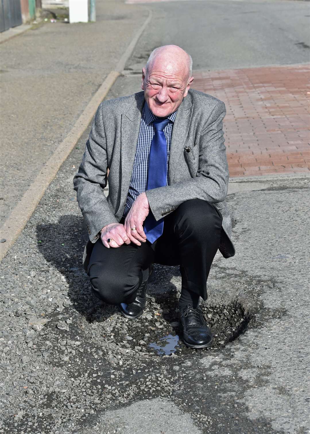 Iain Gregory of Caithness Roads Recovery beside a pothole in Thurso. Picture: Mel Roger