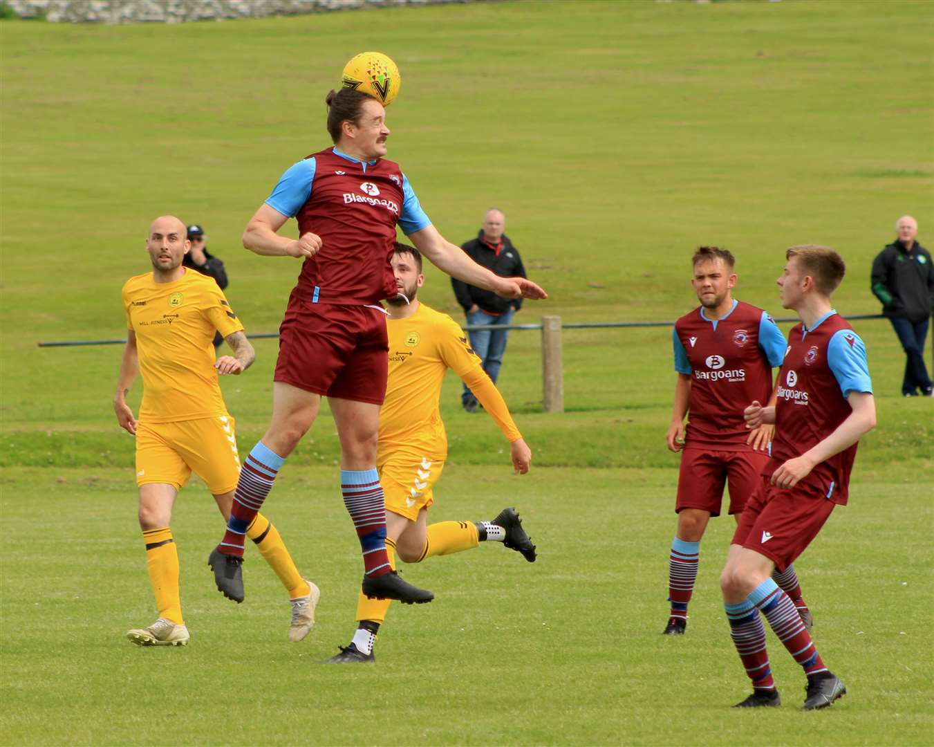 Pentland United defender James McLean gets his head to a high ball.