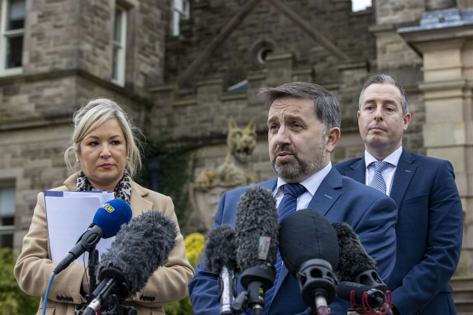 Robin Swann (centre) speaks during a press conference in 2021, as then deputy first minister Michelle O’Neill and then first minister Paul Givan look on (PA)