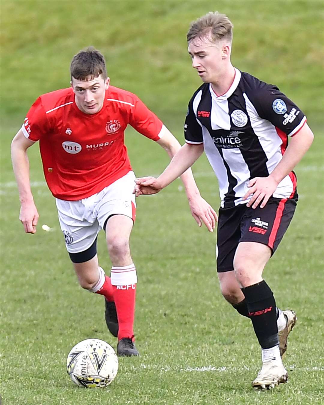 Wick Academy's Cameron Montgomery with Nairn County's Kenny McKenzie. Picture: Mel Roger