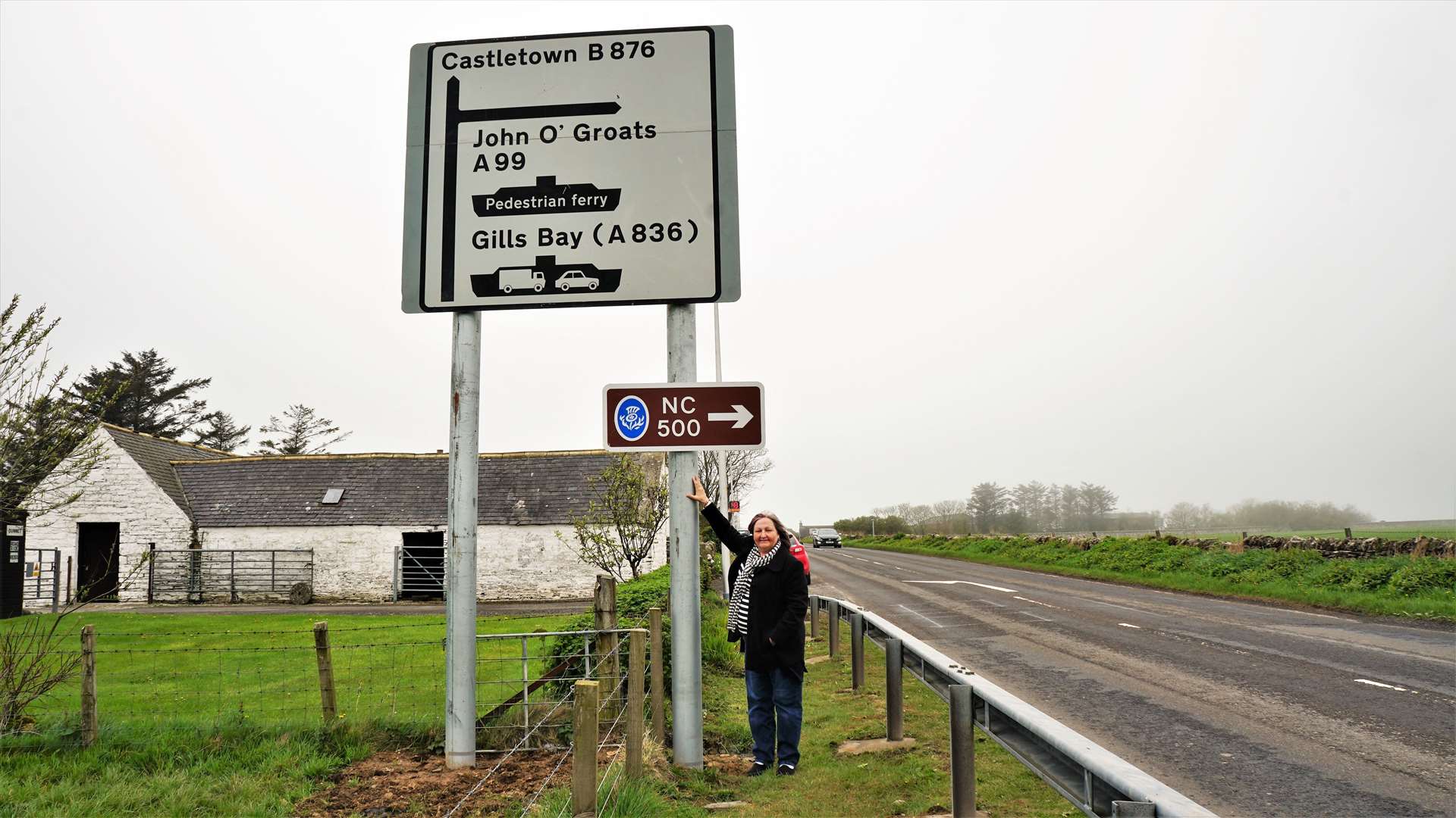 Councillor Jan McEwan stands beside the reinstated signpost that shows where a vital turning on the NC500 is. Picture: DGS