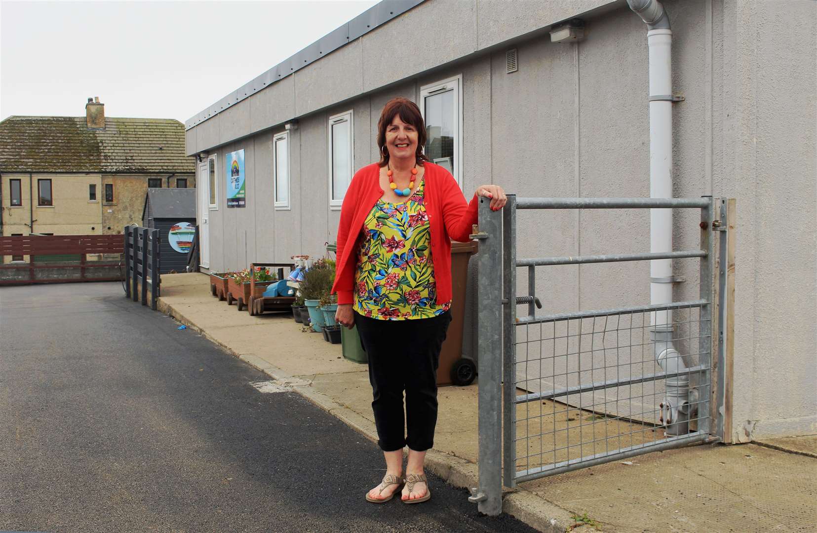 Pat Ramsay, vice-chairperson of Caithness Klics, beside an existing pedestrian gate at the charity's premises in Macleod Road, Wick. Klics' plans would mean a gate giving access to the parking area at the site being moved forward from its previous position.