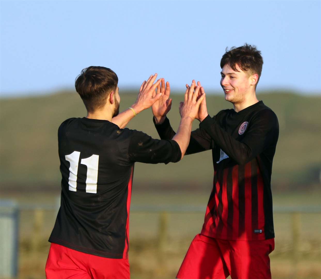 James Mackintosh (right) is congratulated by Jonah Martens after scoring Halkirk United's fourth goal against Invergordon. Picture: James Gunn
