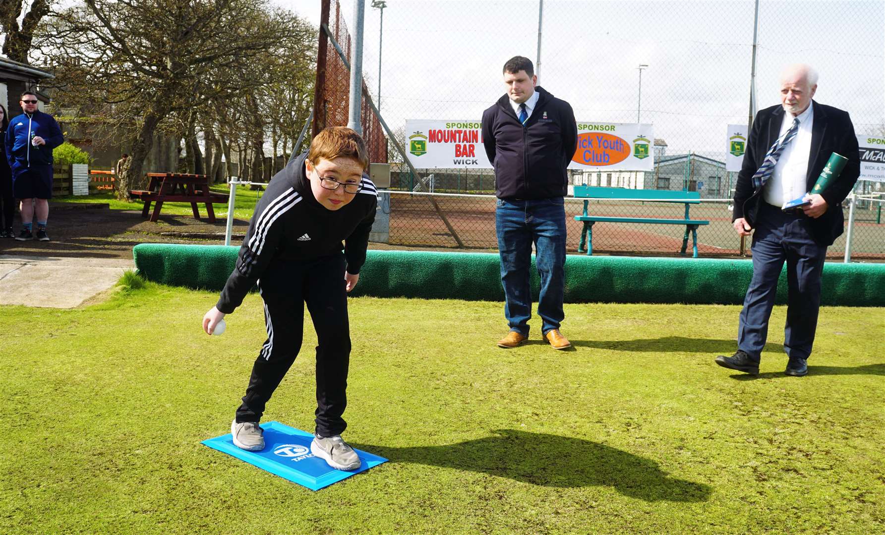 Young Jamie Coull prepares to throw the first jack of the season at Rosebank Bowling Club as president Scott Christie and vice president ‘Toots’ Banks look on. Picture: DGS