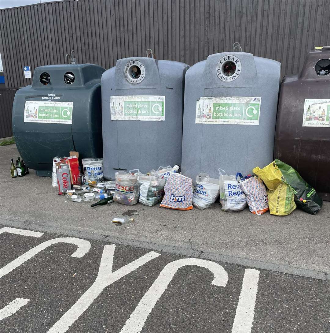 A reader shared this photo showing a bottle bank beside a Wick supermarket where plastic bags crammed with bottles and jars had been left – against council advice – along with a number of loose items of glassware.