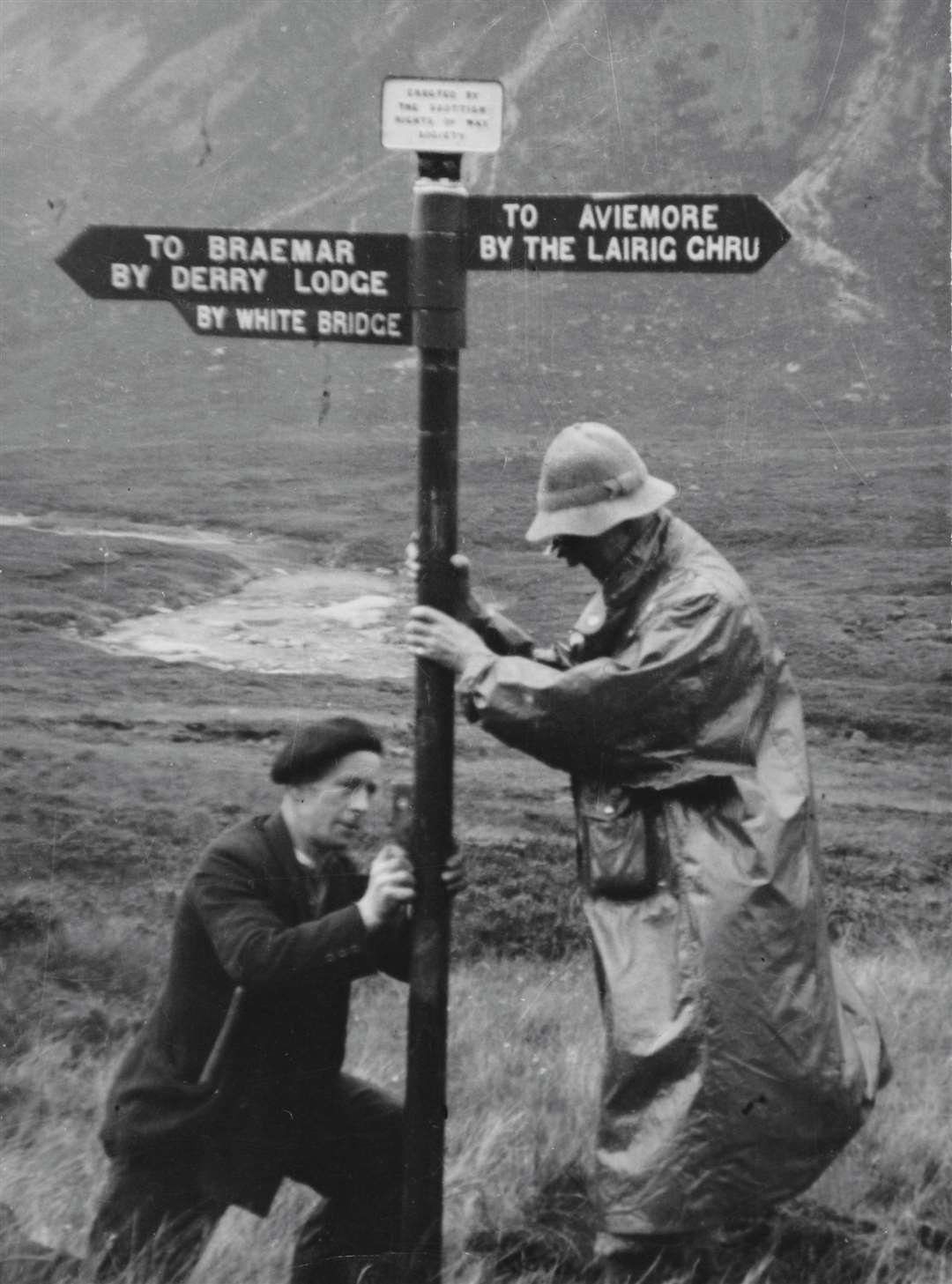 A sign being put back up after the war close to Corrour Bothy at the south end of the Lairig Ghru. The original was put up in 1885. Picture: ScotWays Archive Collection