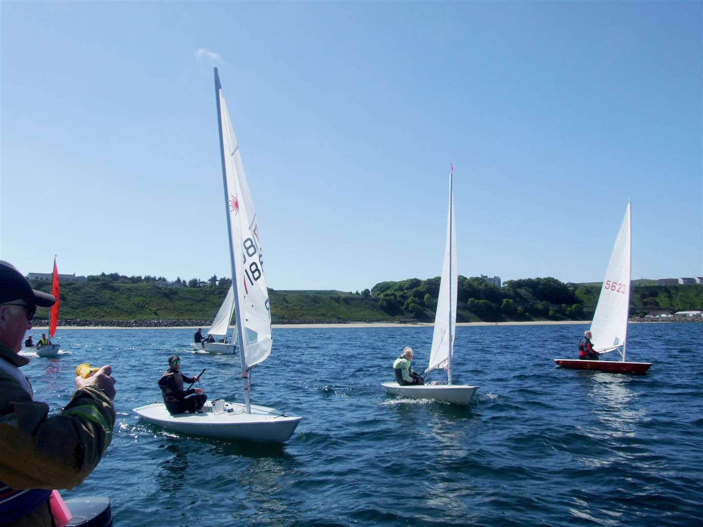 Lasers of Mark Johnston (nearest), Marjory Lord (middle) and Martin Lord (farthest away) with Bosun and Mirror behind at the start of race three.