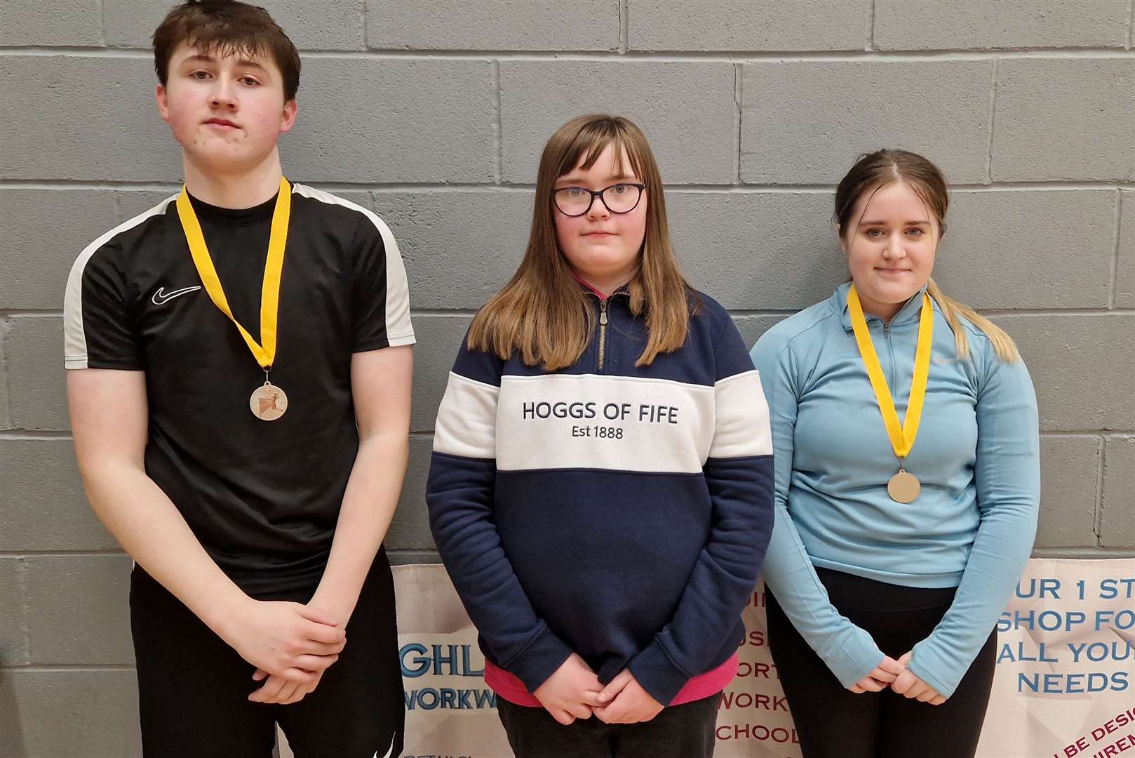 Mixed doubles consolation winners Lewis Malcolm and Hallie Bremner either side of Lexie Mackenzie from Highland Workwear.