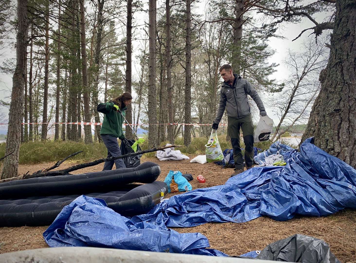 Rangers get to work clearing the dirty campers' rubbish at Loch Morlich.